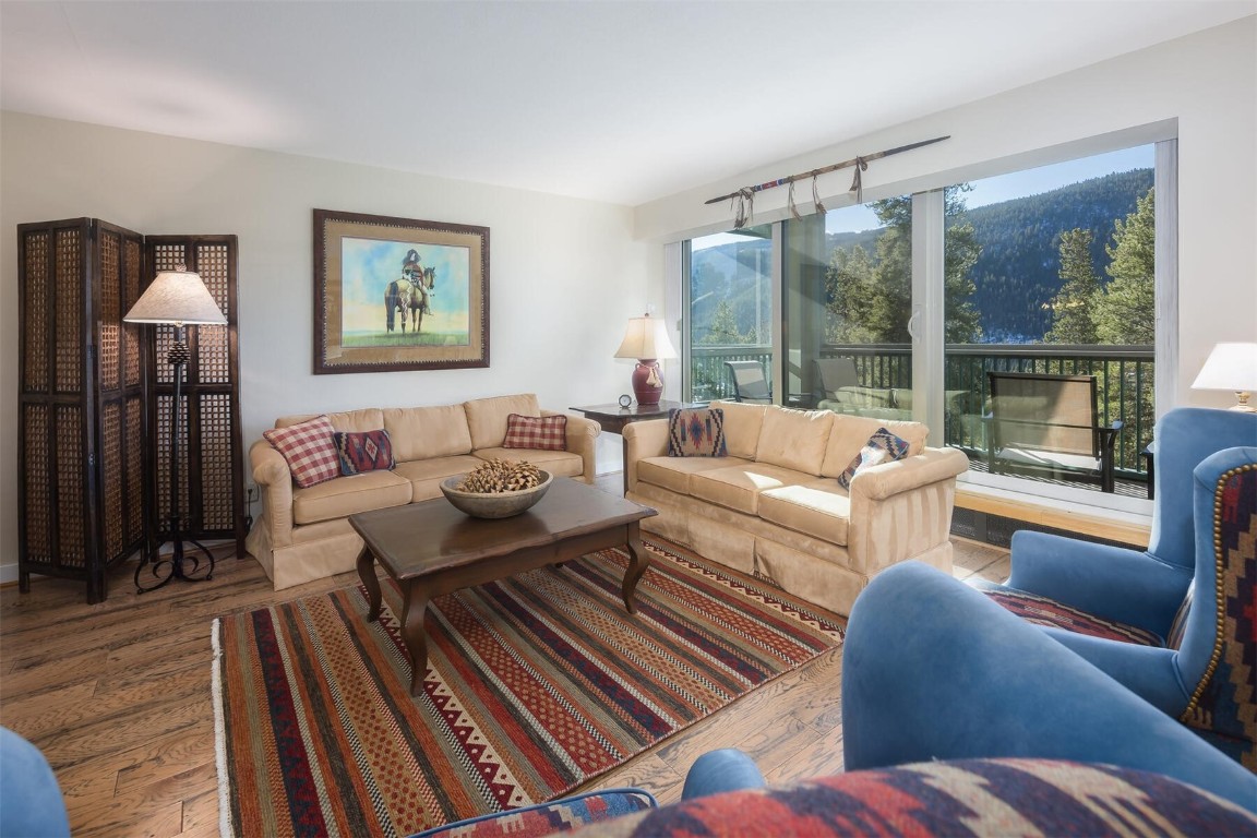 22097 Saints John Road, Unit 2526 Keystone, CO 80435 - Photo 2 of 42 a living room with furniture and a floor to ceiling window