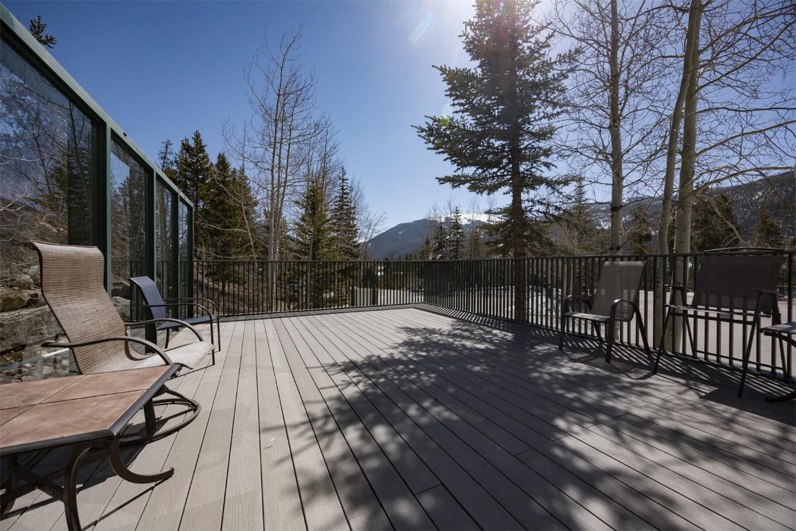 22097 Saints John Road, Unit 2526 Keystone, CO 80435 - Photo 28 of 42 a view of backyard with table and chairs and wooden floor