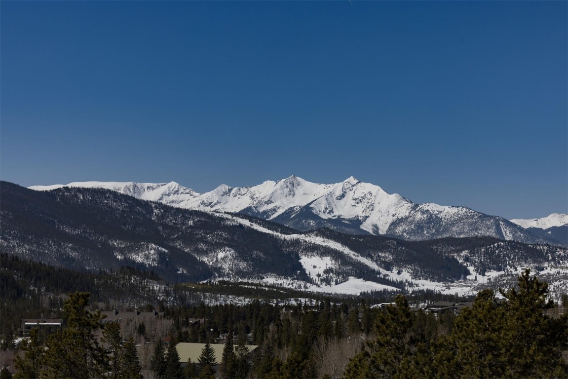 22097 Saints John Road, Unit 2526 Keystone, CO 80435 - Photo 39 of 42 a view of a large building with mountains in the background