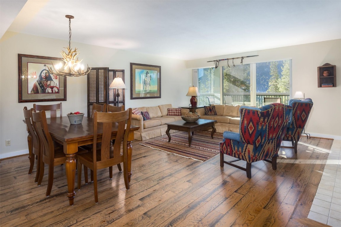 22097 Saints John Road, Unit 2526 Keystone, CO 80435 - Photo 5 of 42 a view of a dining room with furniture window and wooden floor