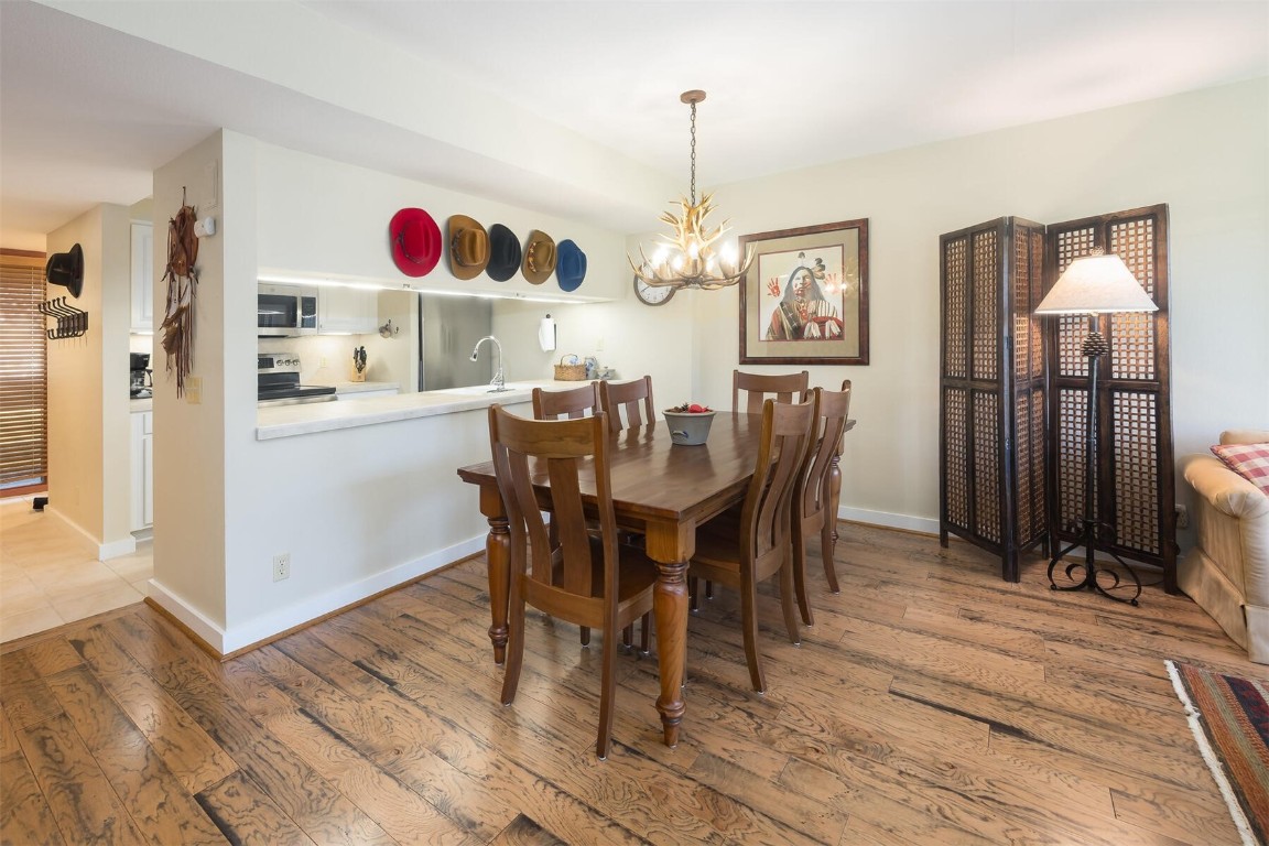 22097 Saints John Road, Unit 2526 Keystone, CO 80435 - Photo 6 of 42 a view of dining room and kitchen with a table chairs
