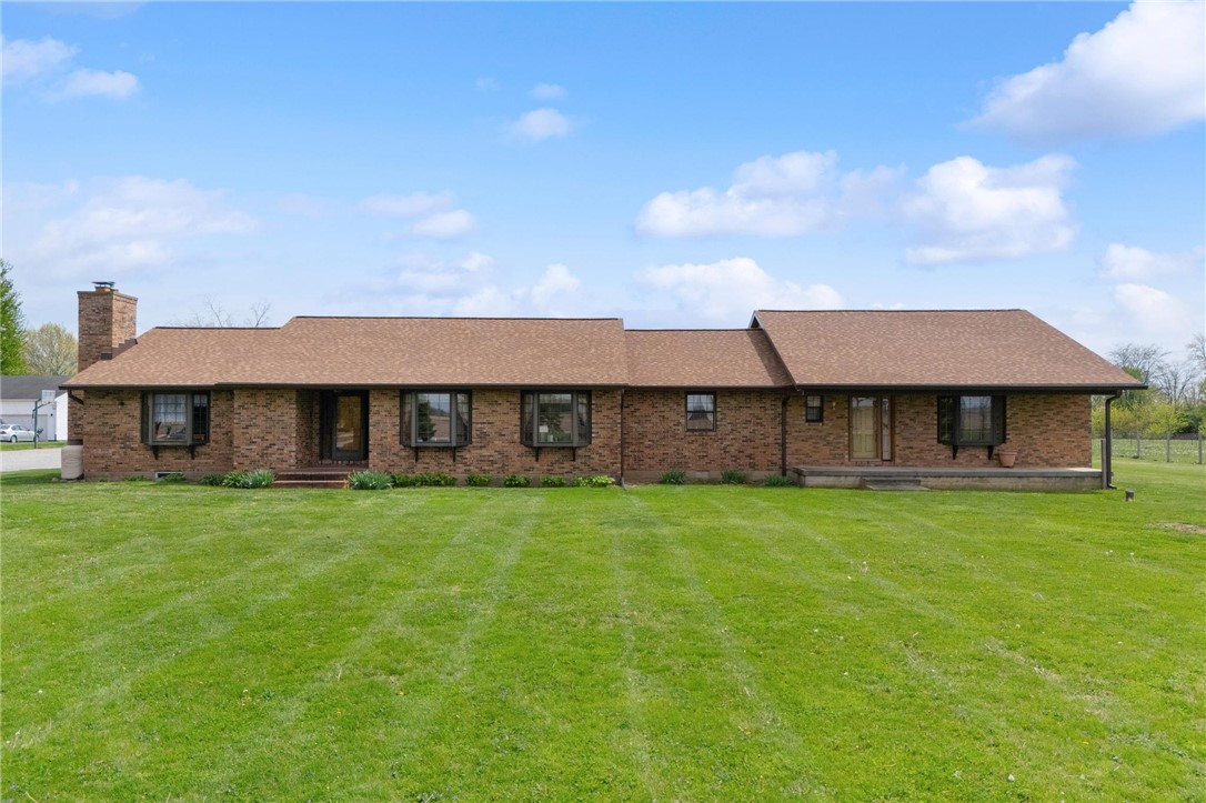 4971 Lackey Road Cedarville, OH 45314 - Photo 1 of 79 This classic brick residence boasts a sprawling front yard, offering a welcoming facade.