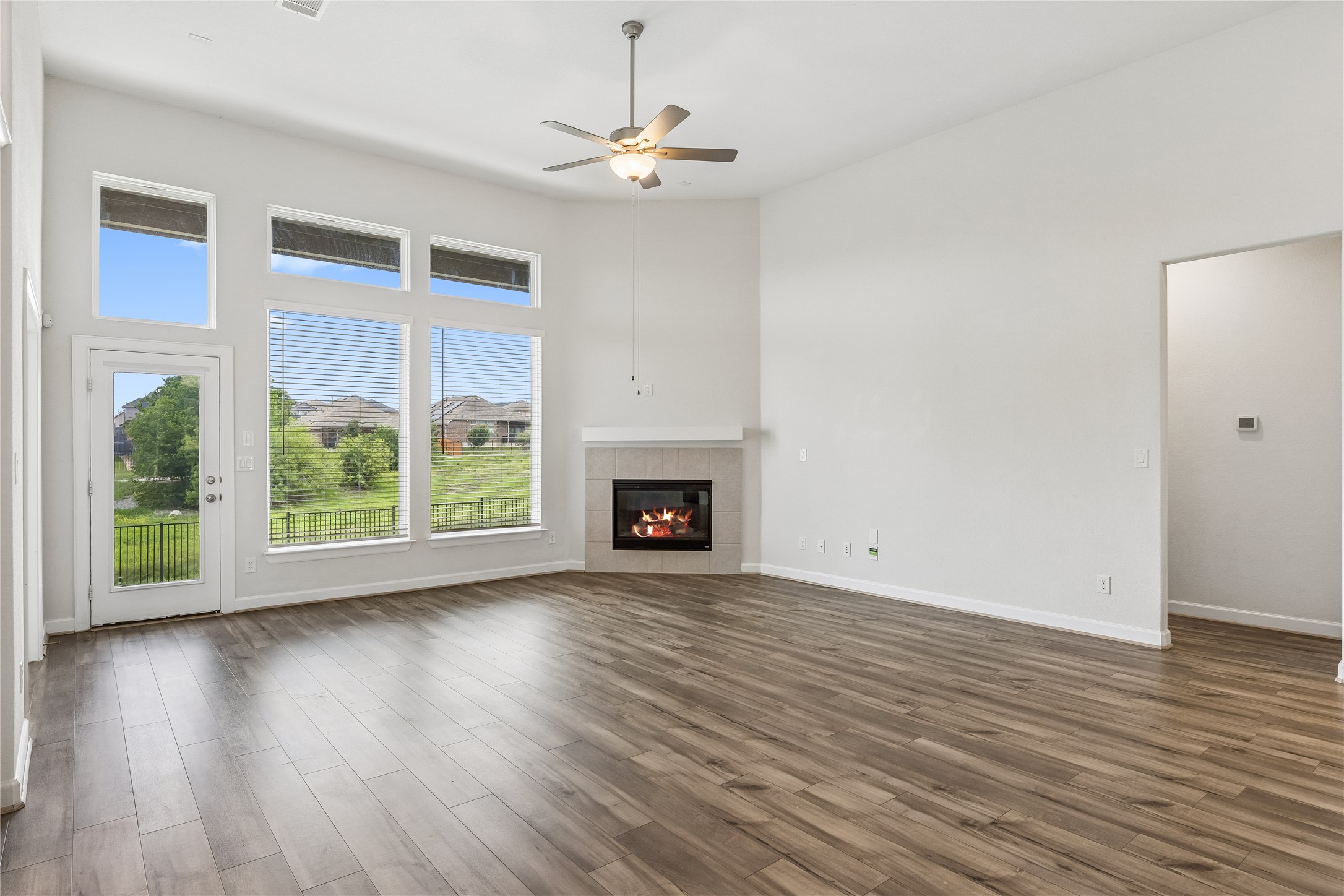 298 Wild Pecan Loop Buda, TX 78610 - Photo 14 of 40 a view of an empty room with wooden floor and a window