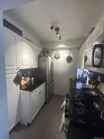 a kitchen with refrigerator and window