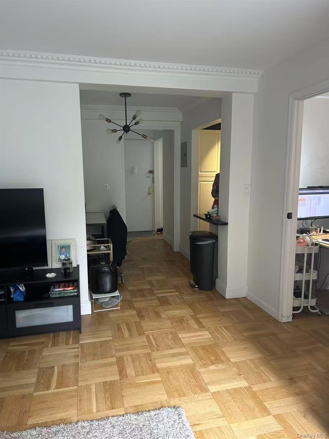 310 Lexington Avenue, Unit 5A Manhattan, NY 10016 - Photo 7 of 9 Hall featuring baseboards and a desk