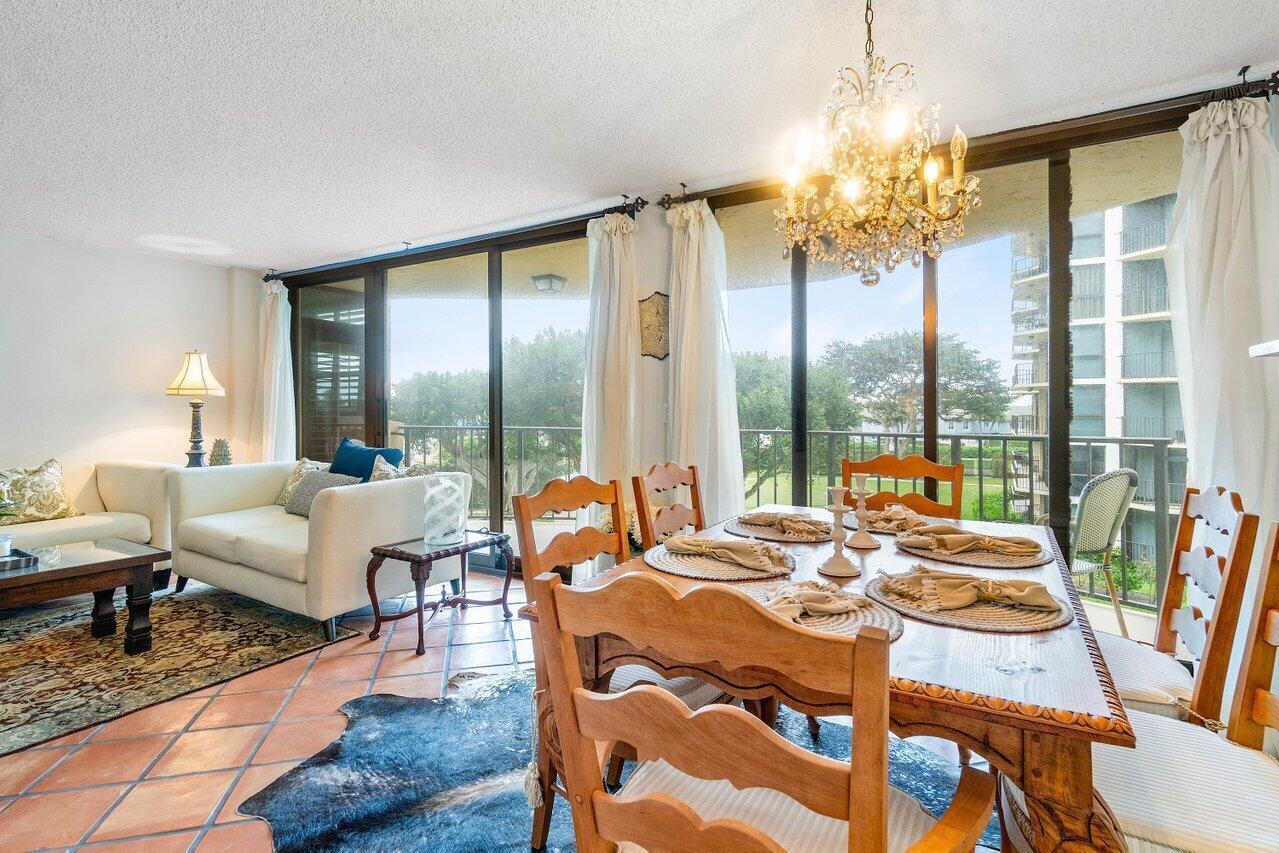 899 Jeffery Street, Unit 3050 Boca Raton, FL 33487 - Photo 5 of 31 a living room with fireplace furniture and a chandelier