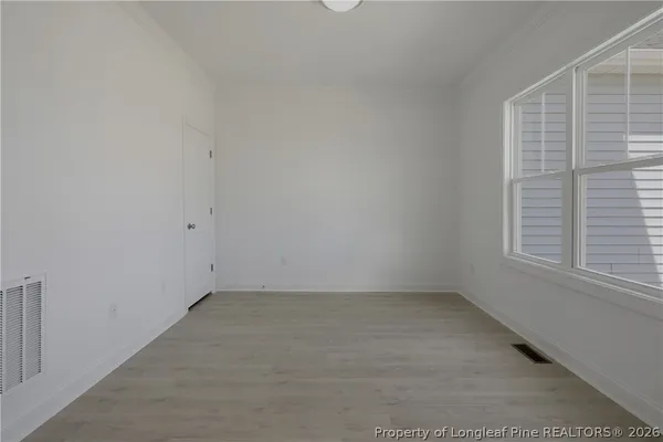 a kitchen with granite countertop white cabinets and a stove