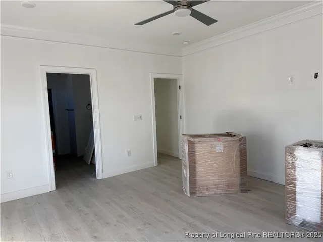 an empty room with closet and fan