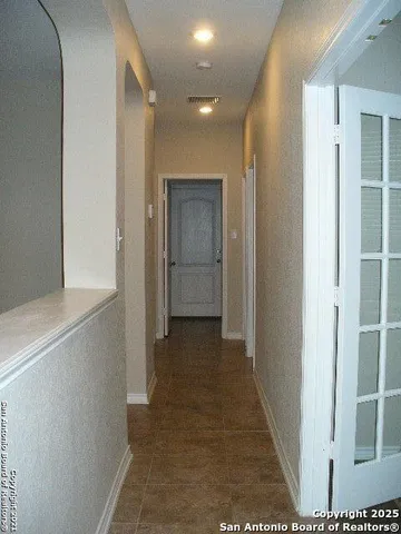 an empty room with wooden floor and a window