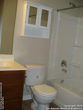 a view of backyard with wooden fence