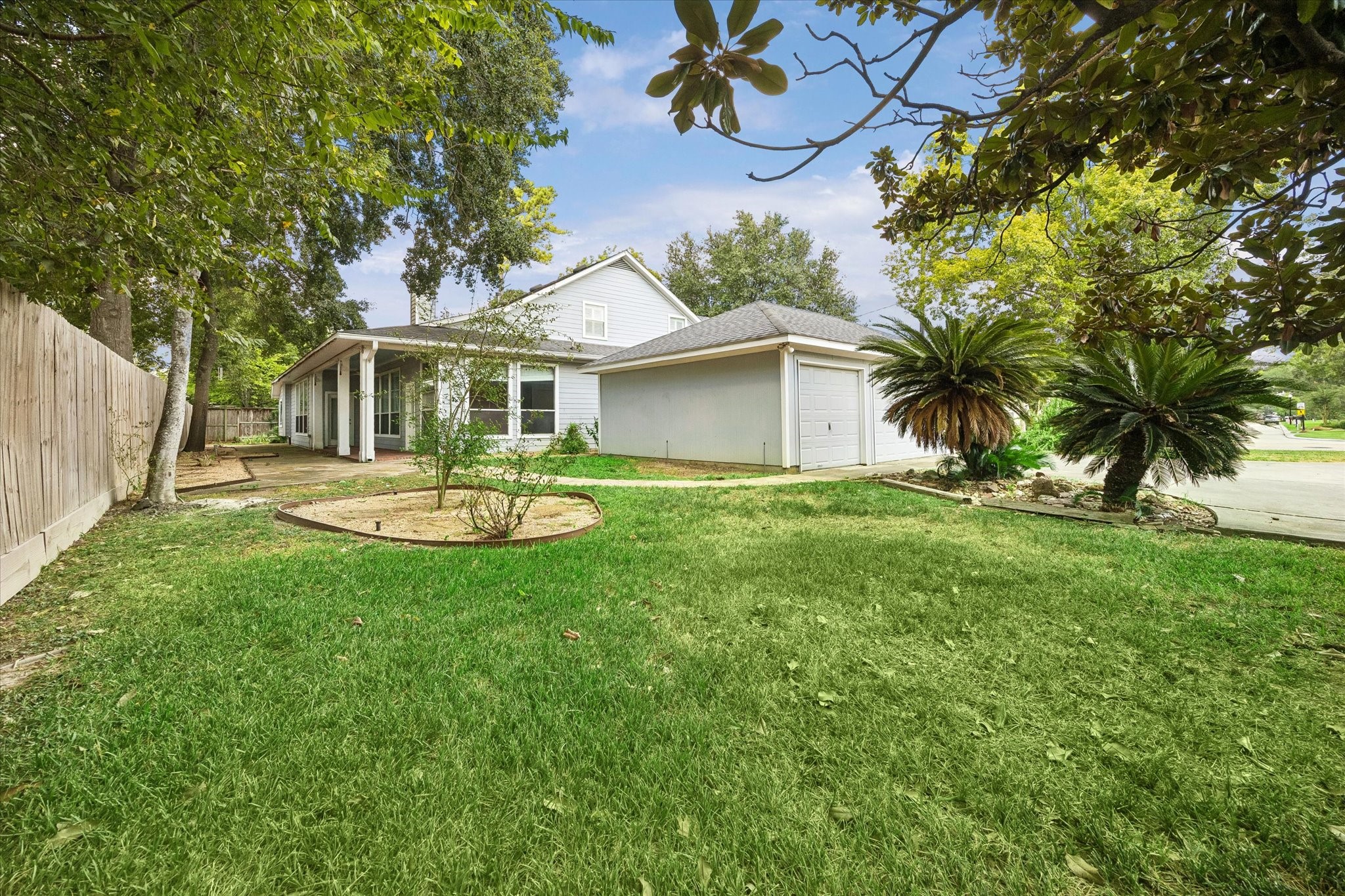 1203 Bingle Road Houston, TX 77055 - Photo 21 of 21 Charming home with a spacious, lush backyard featuring mature trees and a cozy patio, perfect for outdoor relaxation.