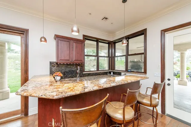 a bathroom with a granite countertop double vanity sink and a mirror
