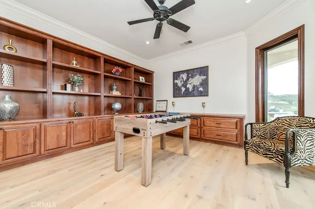 a kitchen with stainless steel appliances kitchen island granite countertop a table chairs and a refrigerator