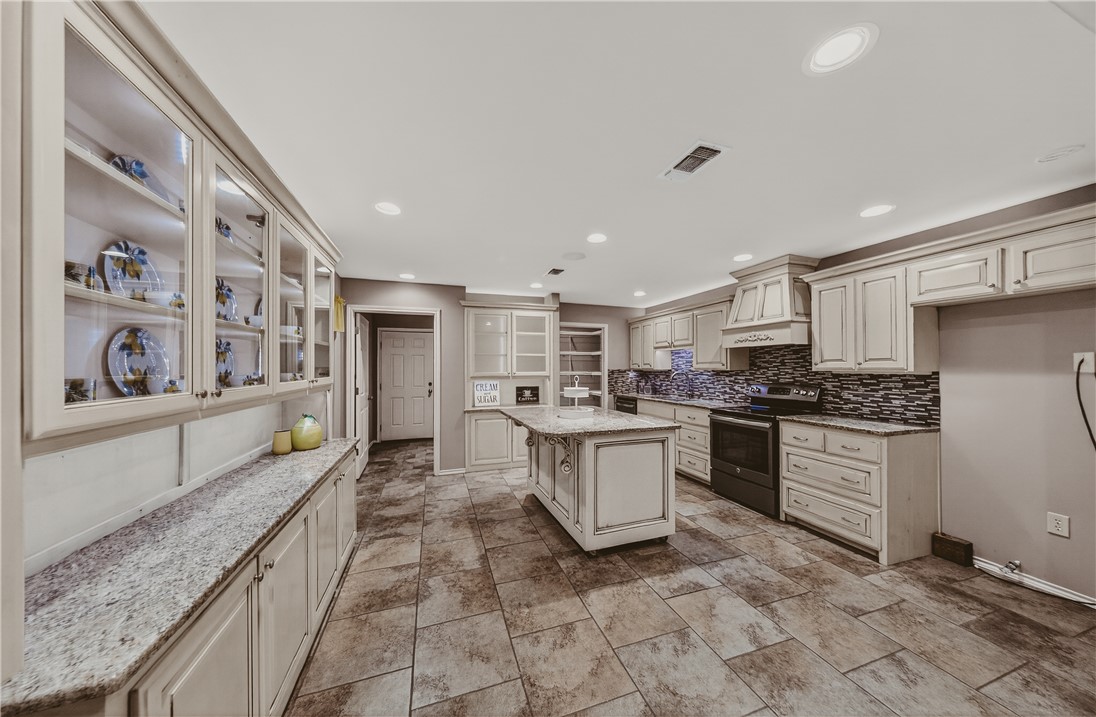 648 Dequeen Lake Road De Queen, AR 71832 - Photo 4 of 46 The kitchen offers extensive cabinetry, including glass-front display cabinets, granite countertops and a central island to make entertaining easy!