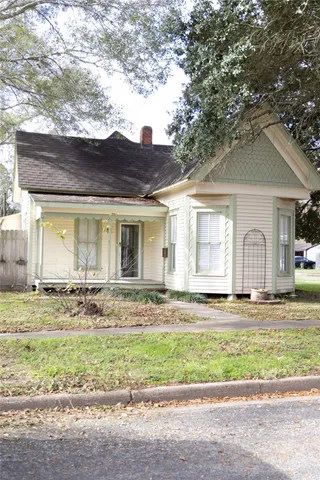 a view of a house with a yard and sitting area
