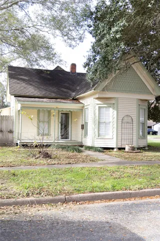 a view of a house with a yard and sitting area