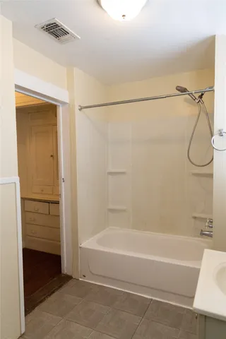 a bathroom with a shower and a bath tub