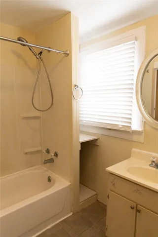 a bathroom with a sink a shower and a bathtub