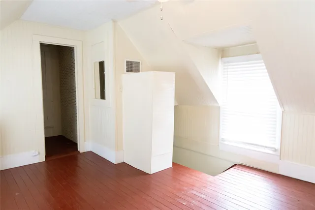 a view of a room with wooden floor
