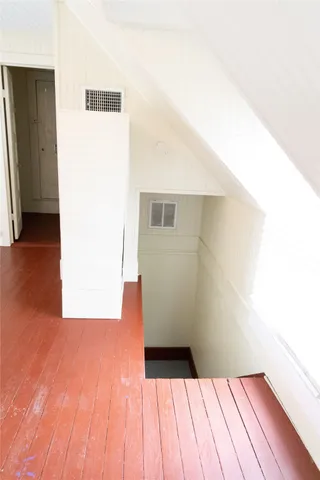 a view of a room with wooden floor
