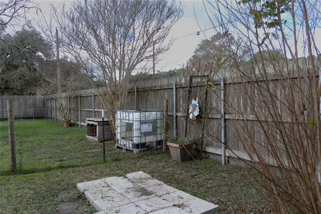 a view of a backyard with wooden fence