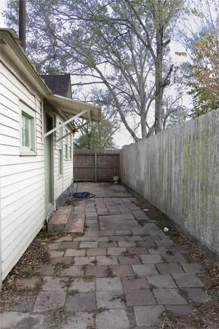 a view of a yard with wooden fence