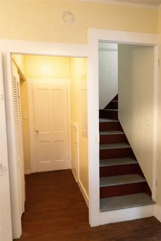 a view of a hallway with wooden floor and entryway