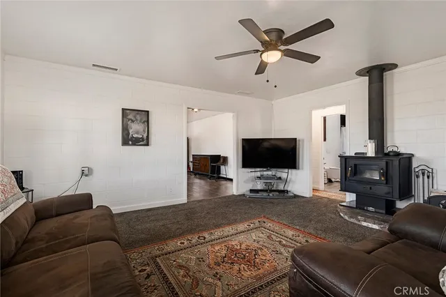 a kitchen with stainless steel appliances a sink a stove a refrigerator cabinets and a window