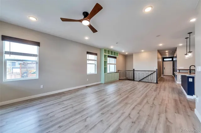 a kitchen with stainless steel appliances kitchen island granite countertop a sink stove and refrigerator