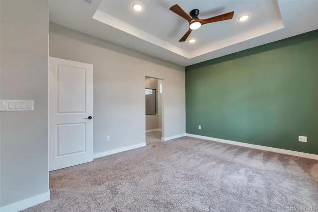 an empty room with closet and a chandelier fan