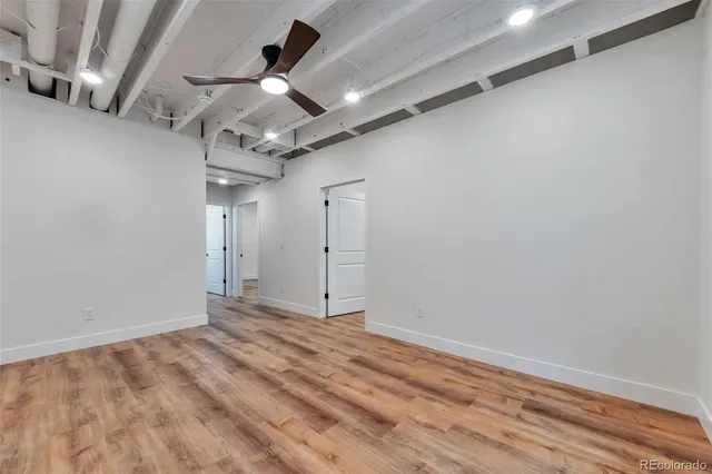 a view of empty room with wooden floor