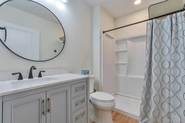 an empty room with ceiling fan and window