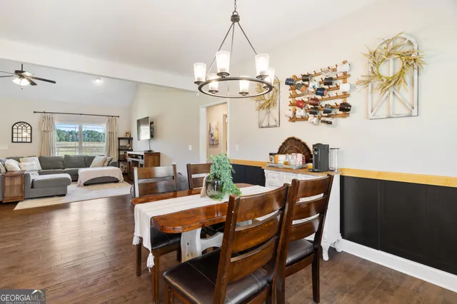 a view of a dining room with furniture wooden floor and chandelier