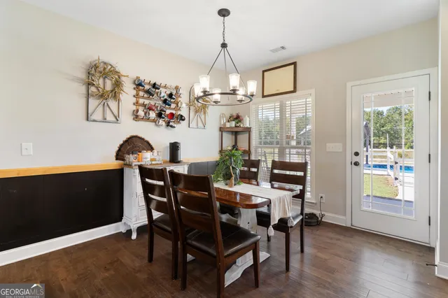 a view of a dining room with furniture wooden floor and chandelier