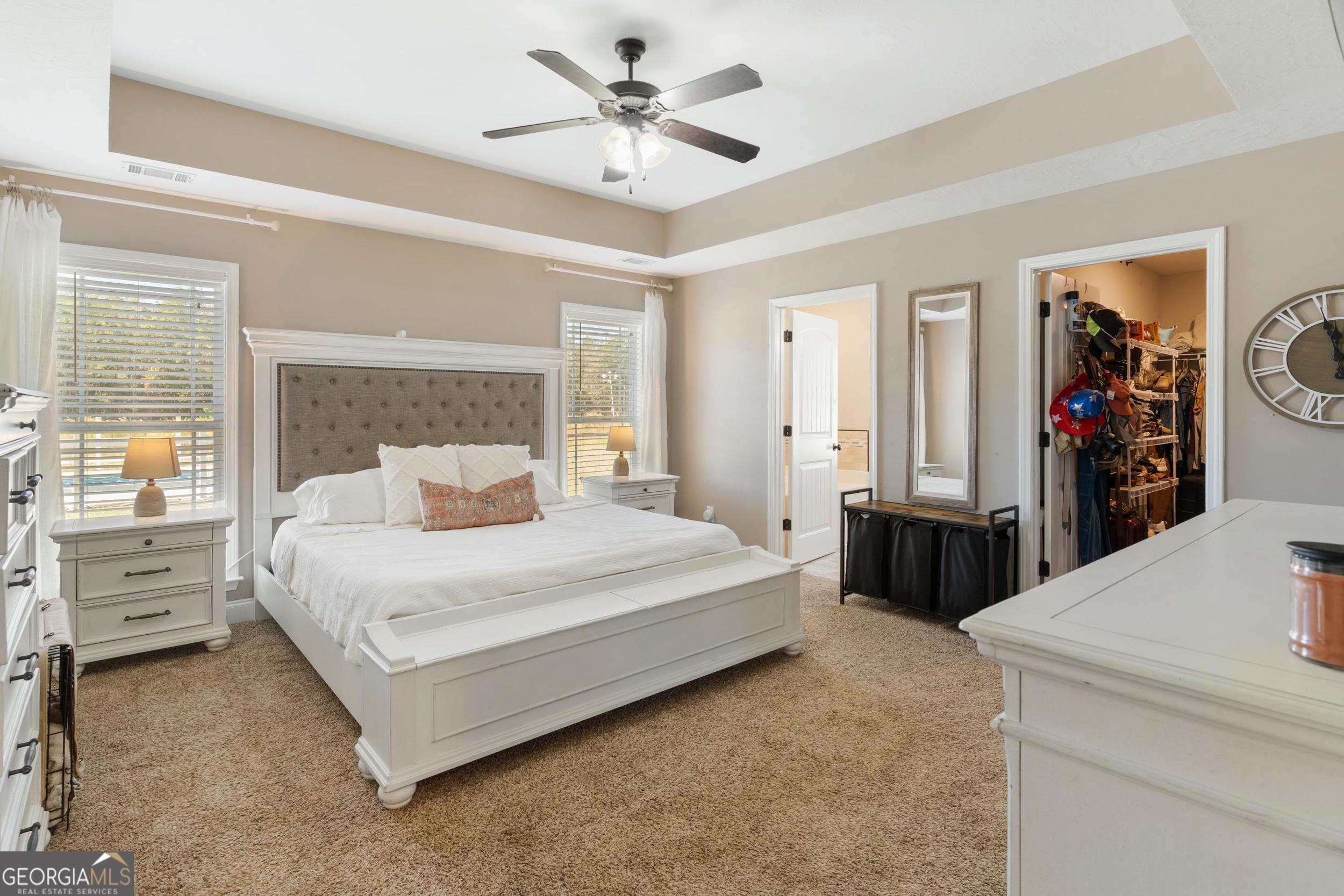 1287 Idlewood-Munnerlyn Road Waynesboro, GA 30830 - Photo 18 of 48 a bedroom with a bed and a chandelier