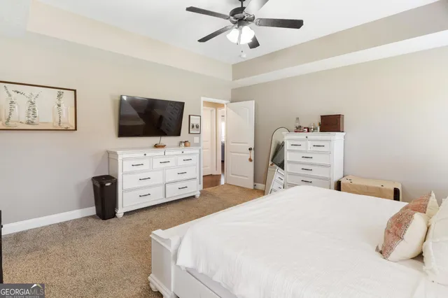 a bedroom with a bed and flat screen tv