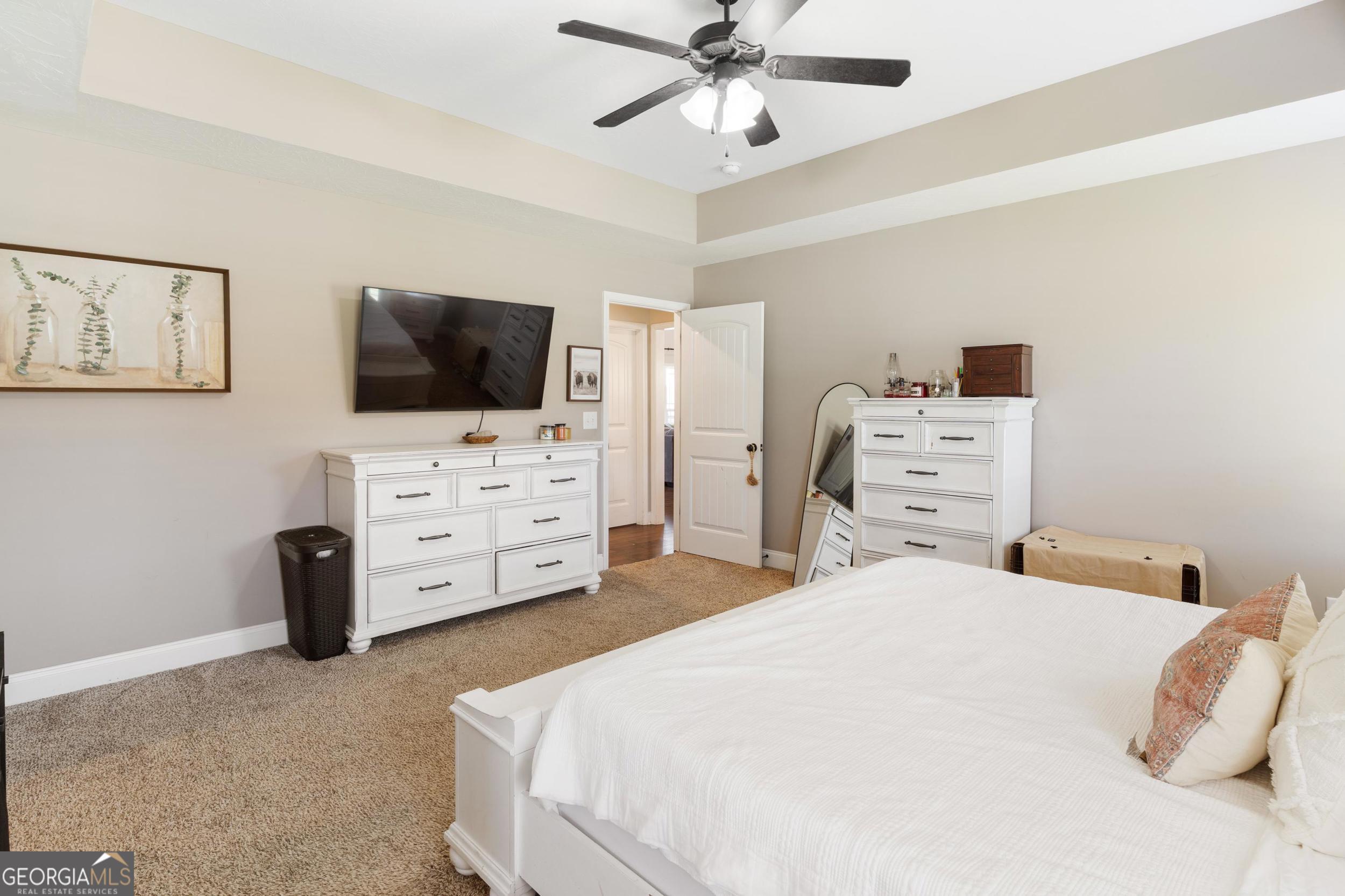 1287 Idlewood-Munnerlyn Road Waynesboro, GA 30830 - Photo 19 of 48 a bedroom with a bed and flat screen tv