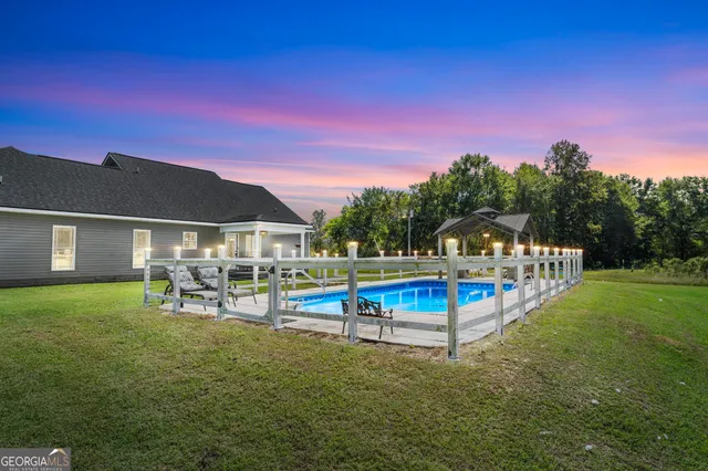 a view of a swimming pool with a table and chairs