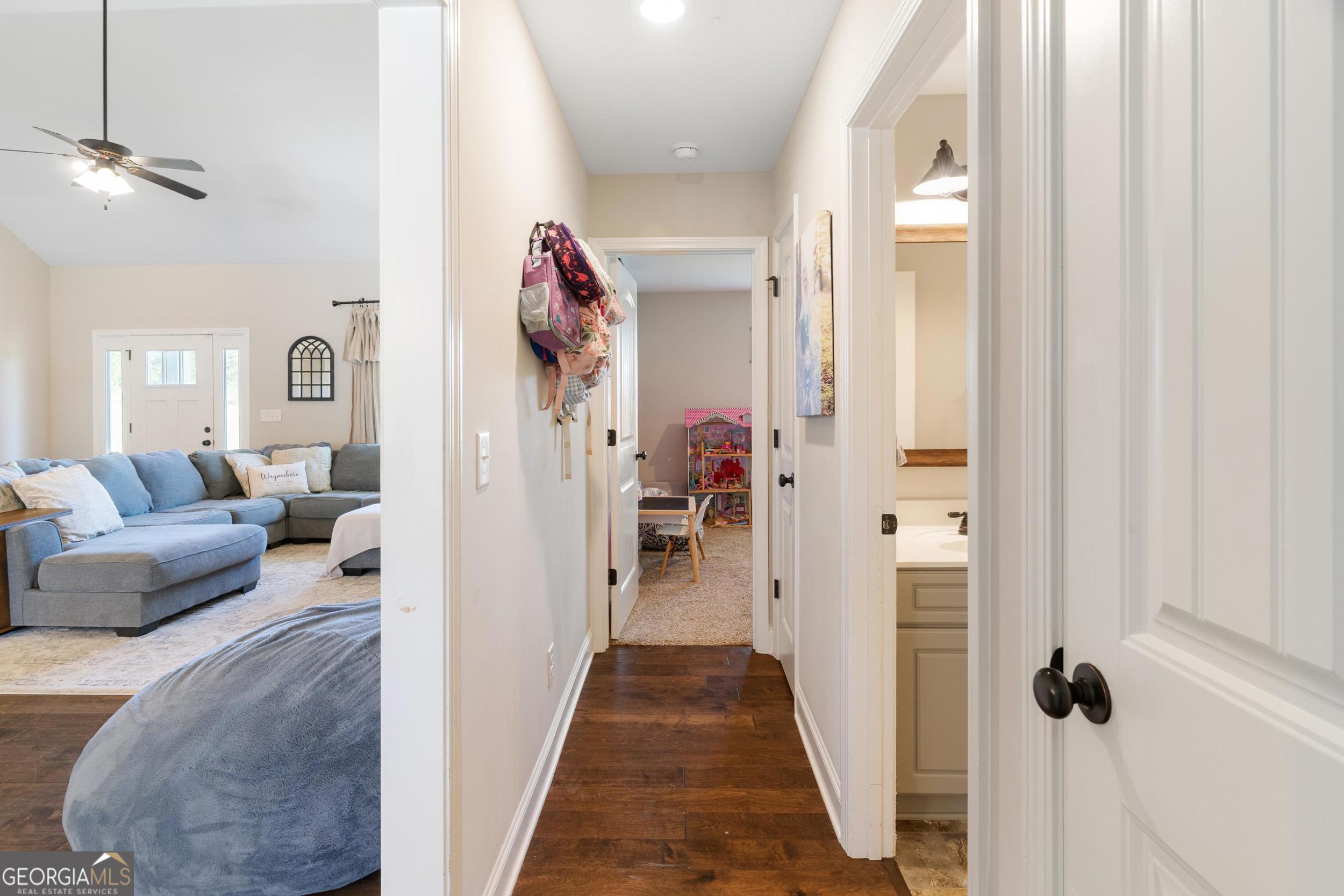 1287 Idlewood-Munnerlyn Road Waynesboro, GA 30830 - Photo 24 of 48 a view of a hallway with a livingroom and a chandelier