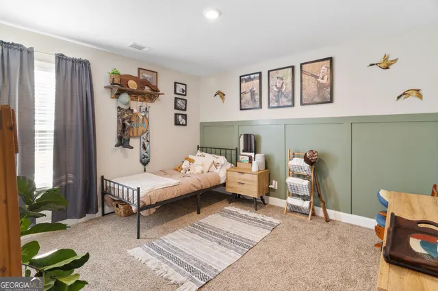 a bedroom with a bed and a couch