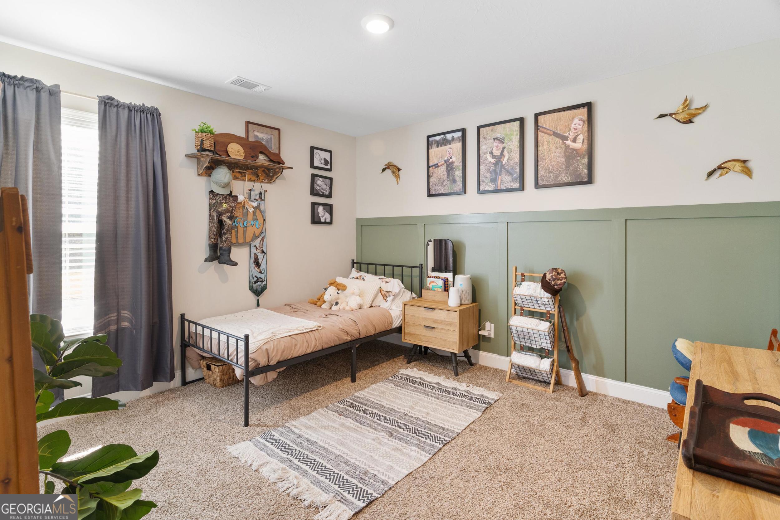 1287 Idlewood-Munnerlyn Road Waynesboro, GA 30830 - Photo 25 of 48 a bedroom with a bed and a couch