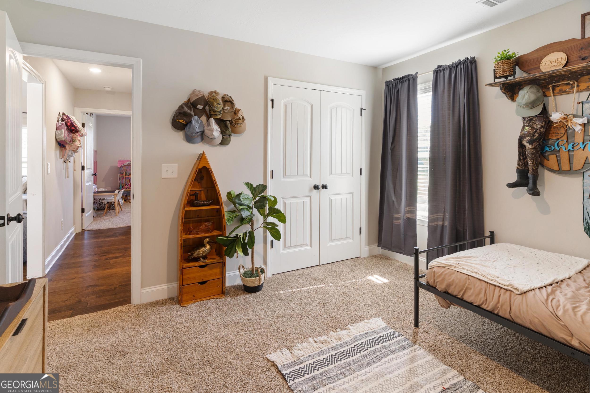 1287 Idlewood-Munnerlyn Road Waynesboro, GA 30830 - Photo 26 of 48 a bedroom with a bed and a chandelier