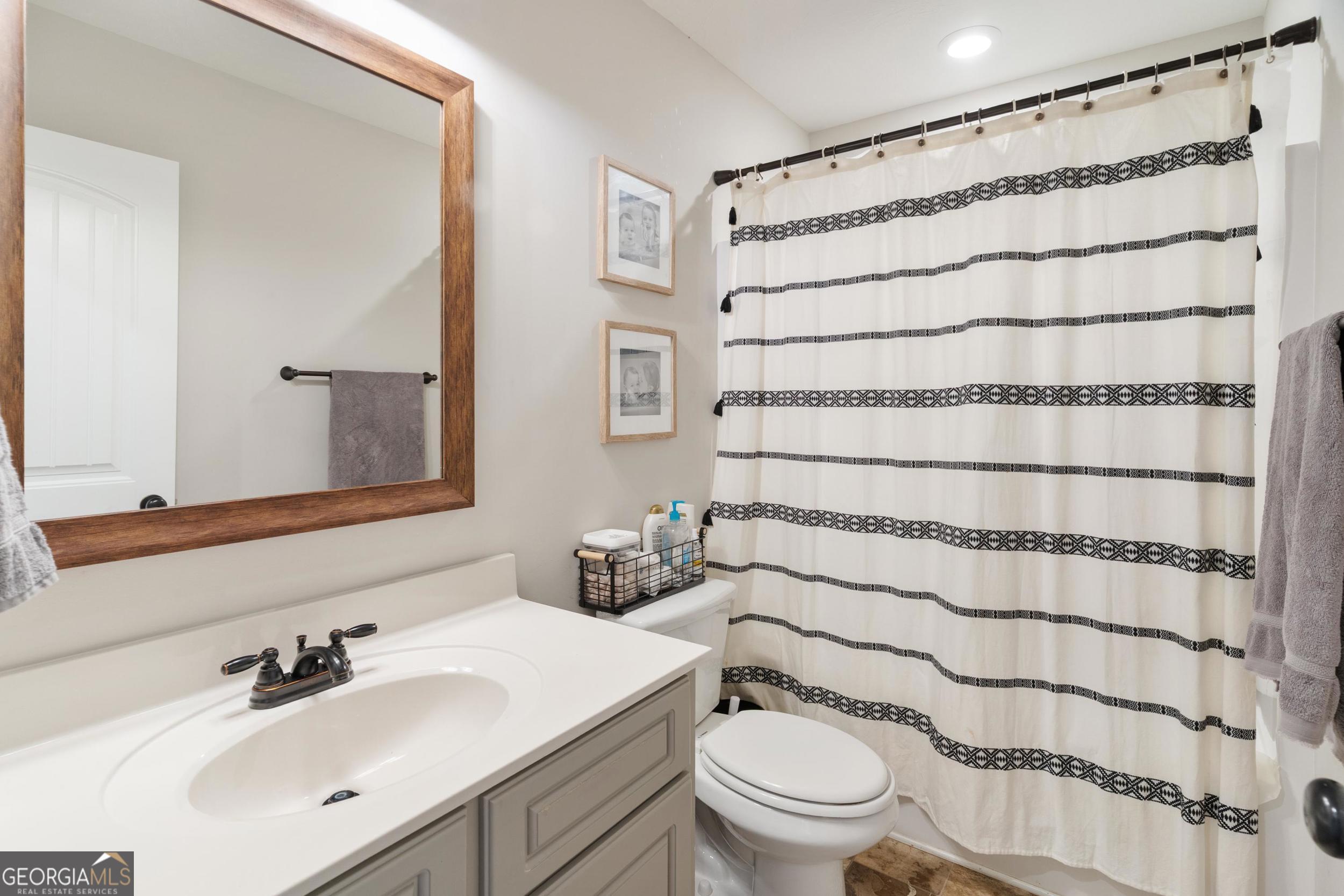 1287 Idlewood-Munnerlyn Road Waynesboro, GA 30830 - Photo 27 of 48 a bathroom with a sink toilet and shower