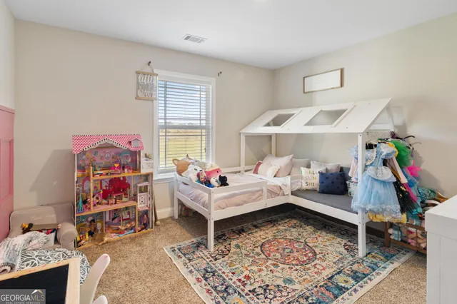 a living room with furniture and a rug
