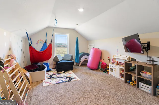 a bedroom with furniture and a flat screen tv