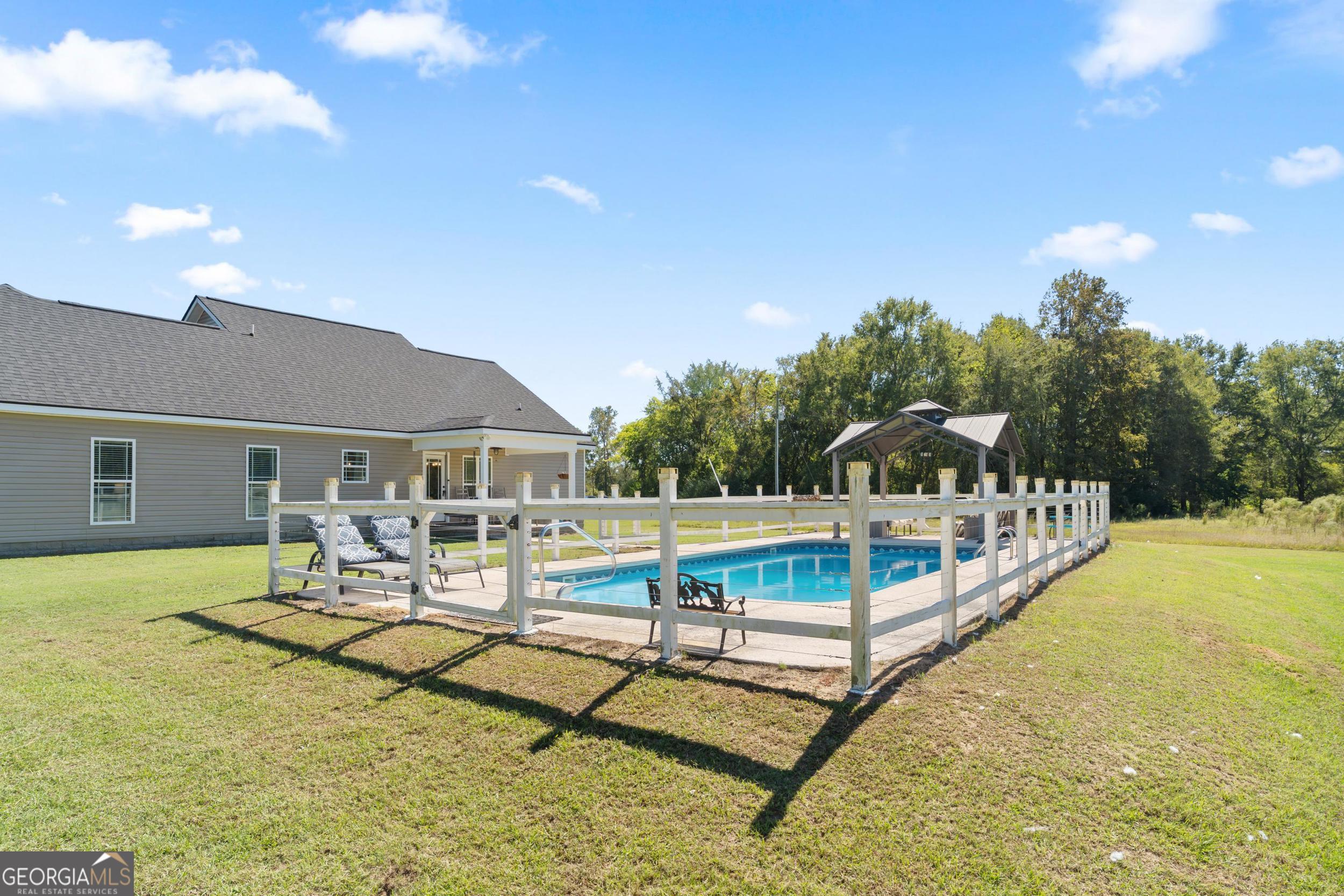 1287 Idlewood-Munnerlyn Road Waynesboro, GA 30830 - Photo 33 of 48 a view of a patio with swimming pool