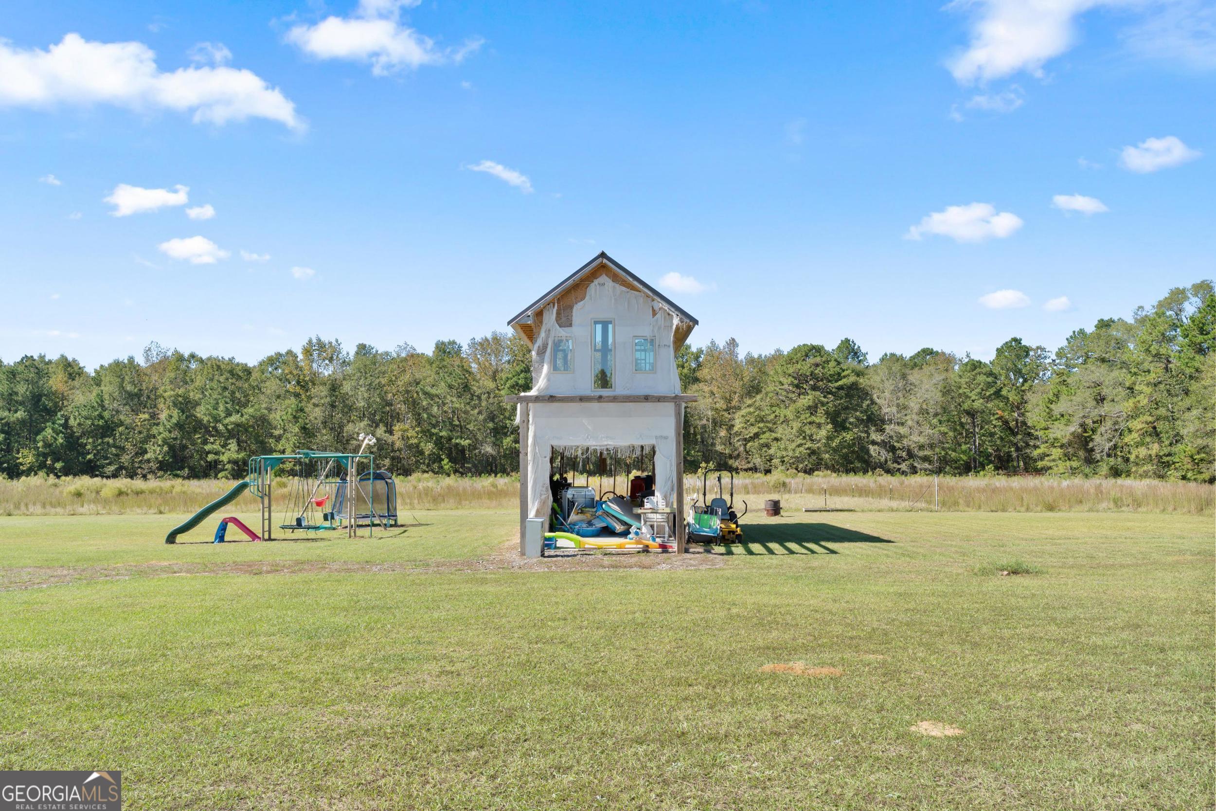 1287 Idlewood-Munnerlyn Road Waynesboro, GA 30830 - Photo 44 of 48 a view of a house with a yard and a lake view