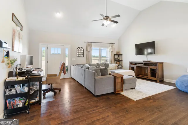 a living room with furniture and a flat screen tv