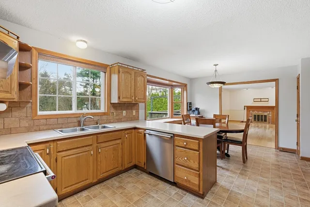 a kitchen with a sink stove and cabinets