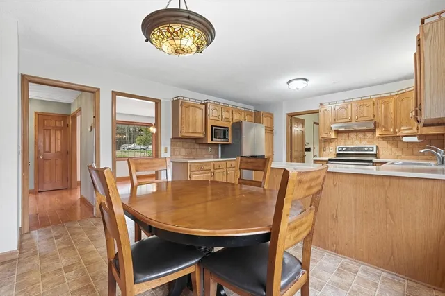 a dining room with furniture and a kitchen view